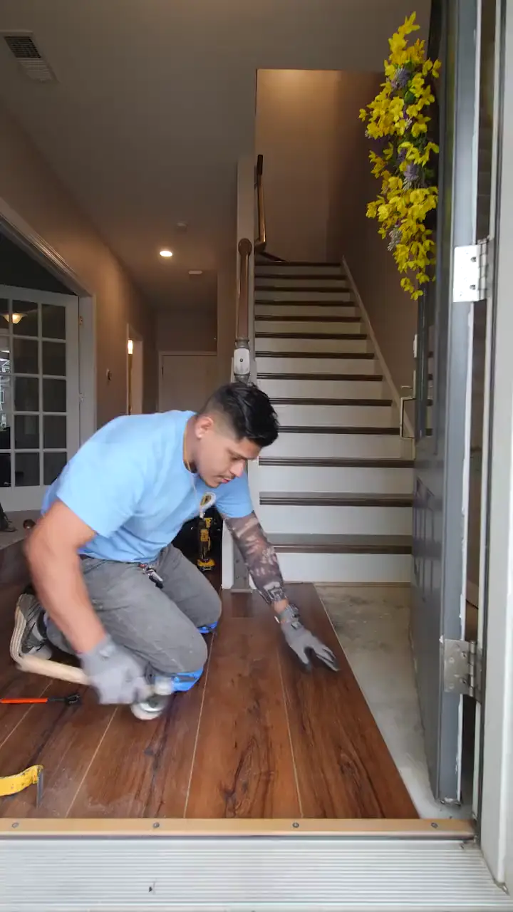 Barefoot Floors installer fitting new flooring at a home entryway