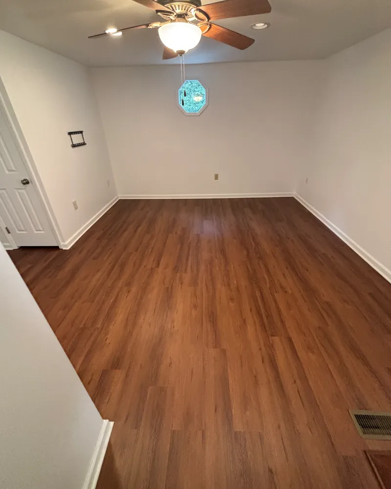 Same bonus room with new warm-toned flooring