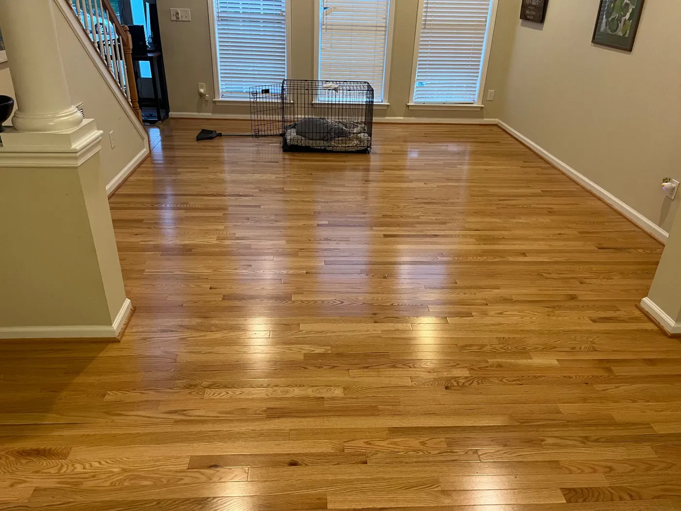 Entry and living area with honey-toned oak hardwood